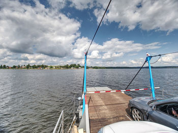 Fishing rod on sea against sky