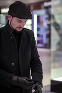 Man wearing warm clothing while standing in store