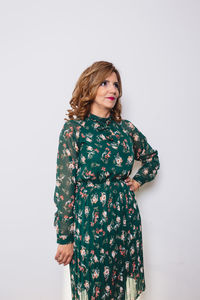 Young woman standing against white background