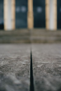 Close-up of metal on street against building