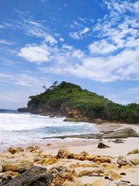 Rocks on beach against sky
