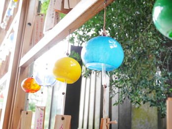 Low angle view of multi colored balloons hanging on wall