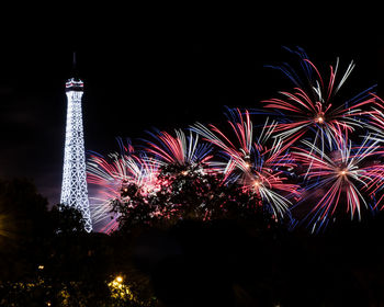 Low angle view of firework display at night