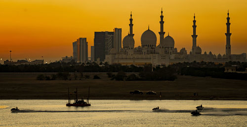 Scenic view of buildings against sky during sunset