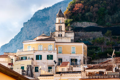 Buildings in town against sky