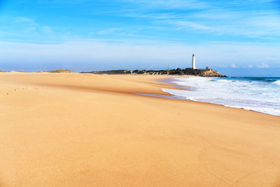 View of beach against cloudy sky