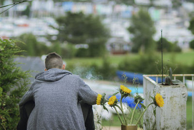 Rear view of man standing by railing