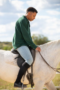 Low section of man riding horse