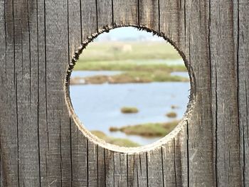 Close-up of heart shape hole on wood
