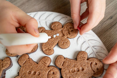 Cropped image of mother preparing cookie at home