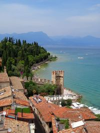 High angle view of sea and mountains against sky