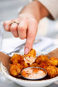 Cropped hand of woman holding food