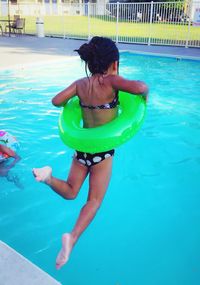 Rear view of girl standing in water