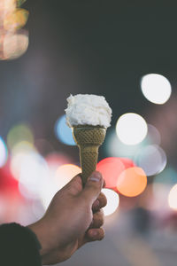 Close-up of hand holding ice cream cone