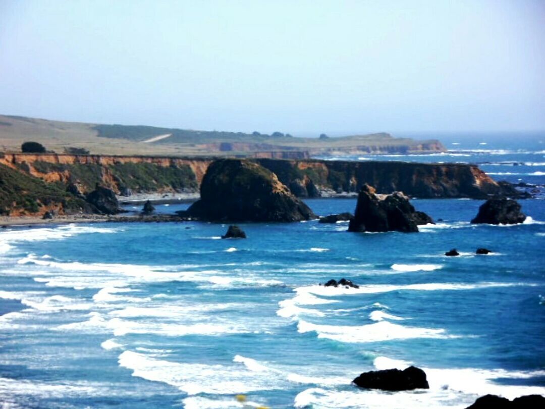 sea, water, clear sky, scenics, beach, tranquil scene, beauty in nature, copy space, rock - object, horizon over water, tranquility, shore, nature, wave, rock formation, blue, idyllic, rock, coastline, sky