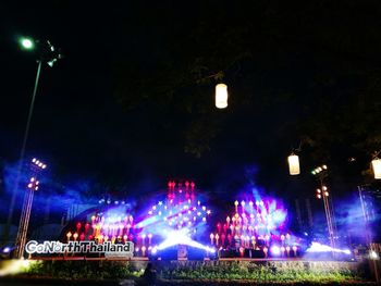 Low angle view of illuminated ferris wheel against sky at night