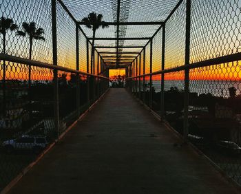 Empty road against sky during sunset