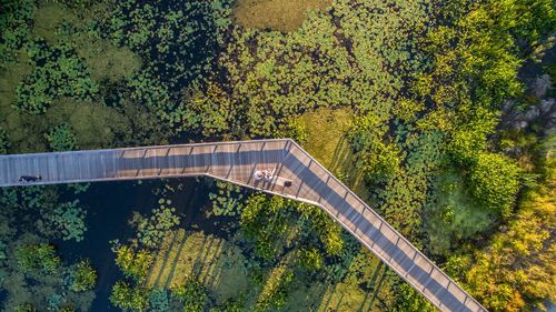 High angle view of people on footbridge over shallow water