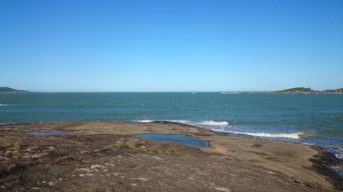 Scenic view of sea against clear blue sky