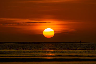 Scenic view of sea against romantic sky at sunset