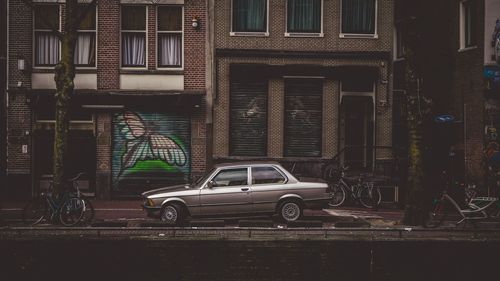 Car parked on street against buildings in city