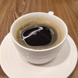 High angle view of coffee cup on table