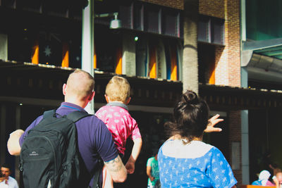 Rear view of people walking outdoors