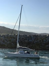 Sailboat on sea against sky