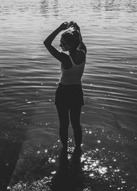 Full length of woman standing at sea shore