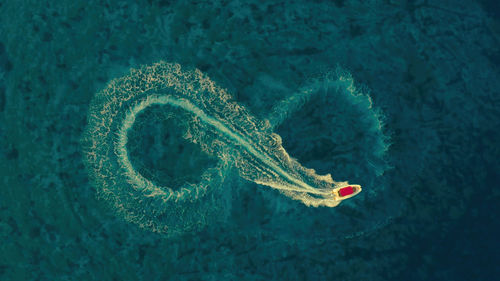 High angle view of boat running in infinity on sea