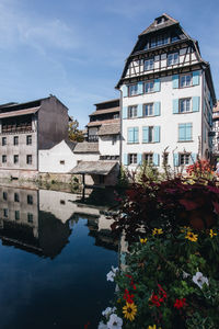 Canal amidst buildings against sky