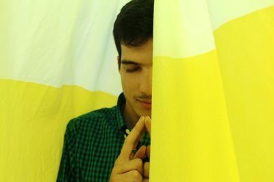 Men meditating by curtains