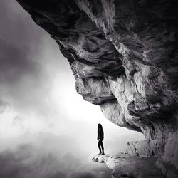 Low angle view of man standing on cliff