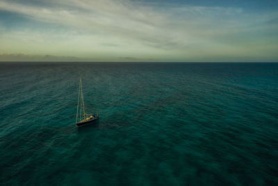 Sailboat sailing in sea against sky