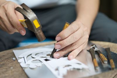 Midsection of manual worker working in workshop