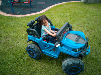 High angle view of girl riding car