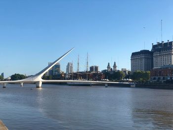 Bridge over river with city in background