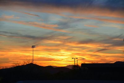 Silhouette of mountain against dramatic sky