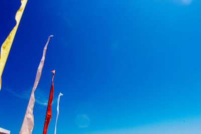 Low angle view of tree against clear blue sky