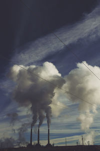 Low angle view of vapor trails against sky