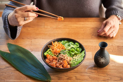 High angle view of woman preparing food on table