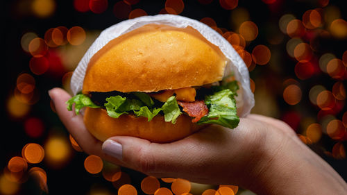 Close-up of hand holding burger