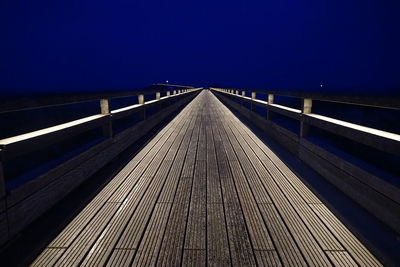 Bridge against clear sky at night