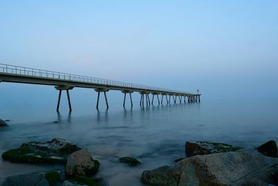 Bridge over sea against sky