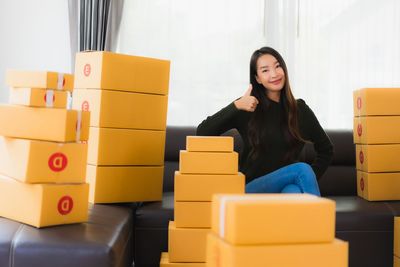 Portrait of a young woman sitting on stack