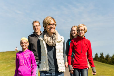 Family standing on field