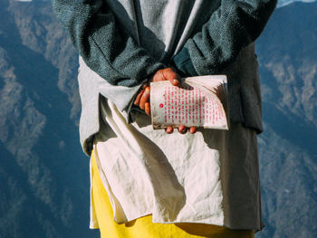 Close-up of man holding umbrella standing in winter