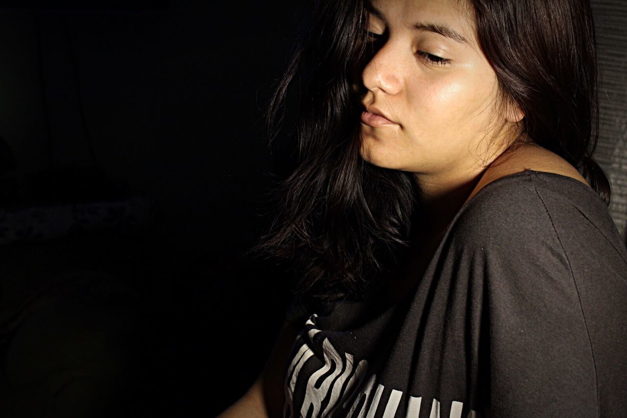 one person, portrait, young adult, black background, dark, adult, emotion, hair, copy space, long hair, women, sadness, indoors, headshot, hairstyle, looking, studio shot, beauty, contemplation, beautiful woman, depression - sadness, human face, teenager, social issues