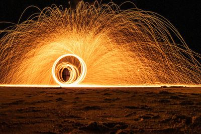 Low angle view of illuminated lighting equipment at night