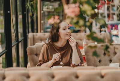 Portrait of young woman sitting outdoors